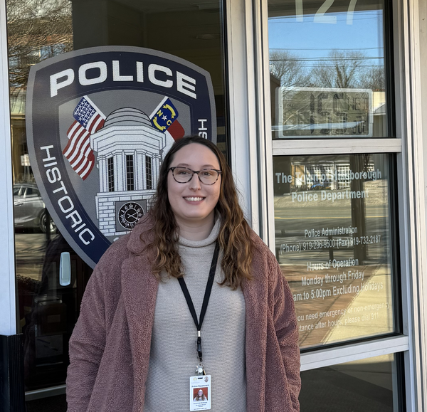Savannah Gilliland in front of the Town of Hillsborough Police Station