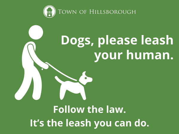 Image of a new sign promoting using a leash while walking dogs. It reads, "Dogs, please leash your human. Follow the law. It's the leash you can do."