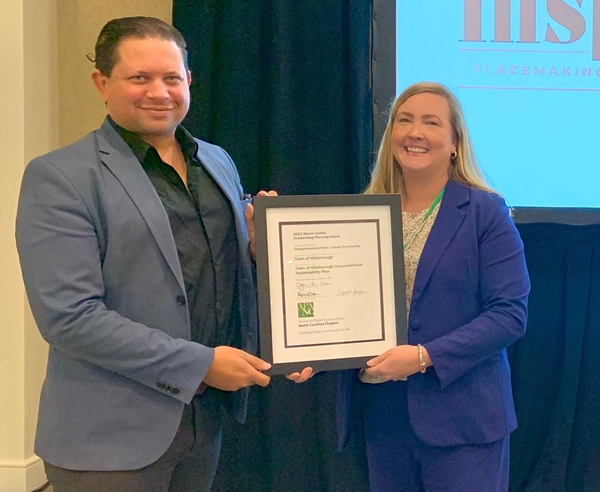 Image of Matt Hughes and Shannan Campbell with the framed award