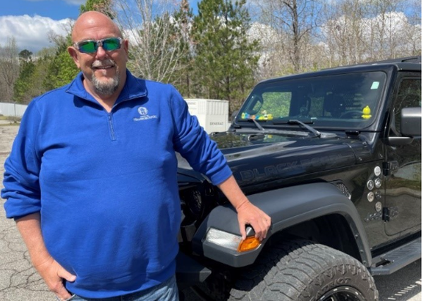 Image of David Moore with a black Jeep Wrangler