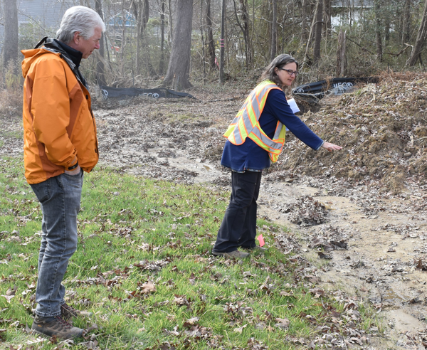 Image of stormwater staff surveying a troubling runoff area